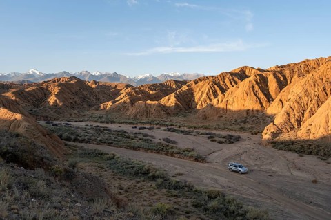 Off-road vehicle on off-road road, eroded hilly landscape, Badlands, Valley of the Forgotten