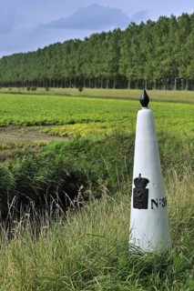 White boundary, border post between the Netherlands and Belgium in polder, Meetjesland
