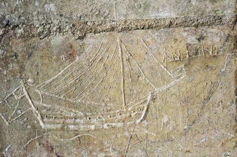 Old graffiti of galleon sailing ship carved on rampart wall of the citadel at Brouage,