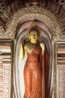 Buddha figure inside Dambulla cave Buddhist temple complex, Sri Lanka, Asia