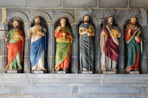 Six statues of saints in a restored version in front of the entrance to the Saint-Sauveur church on