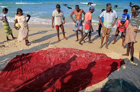 Traditional fishing hauling nets Nilavelli beach, near Trincomalee, Eastern province, Sri Lanka,