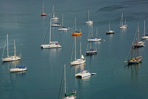 Several sailing boats on calm water with visible reflections, Monte da Guia, Horta, Faial Island,