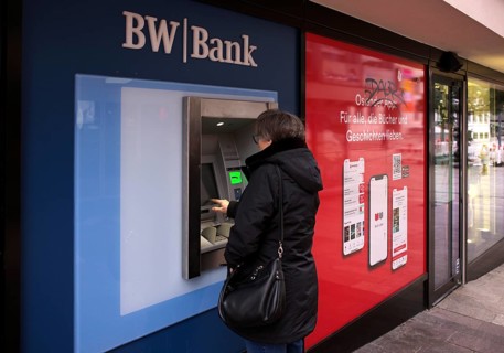 Elderly woman, best ager, types in PIN, ATM of BW-Bank Baden-Wuerttembergische Bank, logo,