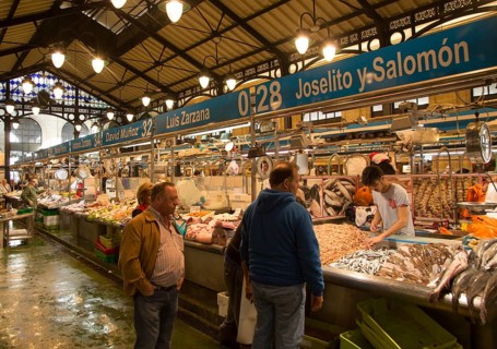 People shopping at fishmonger stalls inside historic covered market building, Jerez de la Frontera,