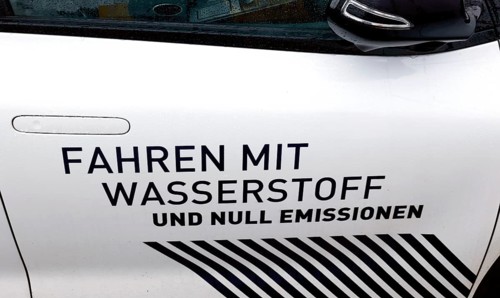 Hydrogen slogan Driving with hydrogen and zero emissions on a hydrogen-powered vehicle, Berlin, 11