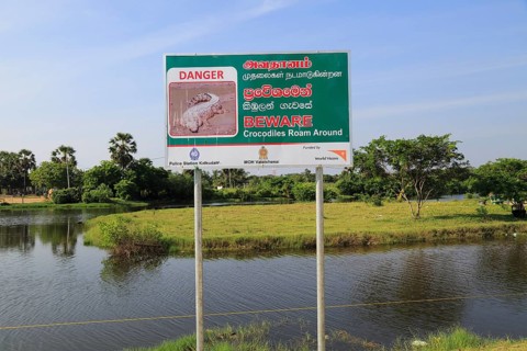 Danger sign warning of crocodiles, Pasikudah Bay, Eastern Province, Sri Lanka, Asia