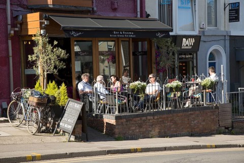People sitting outside cafe bar, Oystermouth, Mumbles, Gower peninsula, near Swansea, South Wales,
