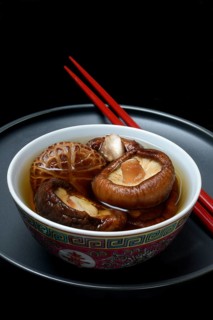 Dried shiitake mushrooms in a bowl, soaked in water