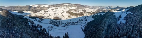 View over Chatzenstaeg, rocky ridge, to Ramiswil and Passwang, Jura Mountain Range in winter, drone