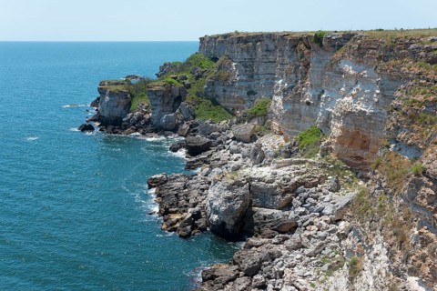 Picturesque cliffs with eroded rock formations on the edge of the sapphire blue sea, cliffs, Kamen
