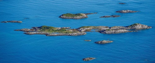 Rocky islands in the blue sea, sea with archipelago islands, Ulvagsundet, Vesteralen, Norway,