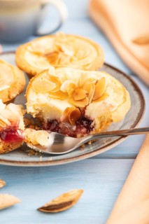 Traditional portuguese cakes pasteis de nata, custard small pies with almonds with cup of coffee on