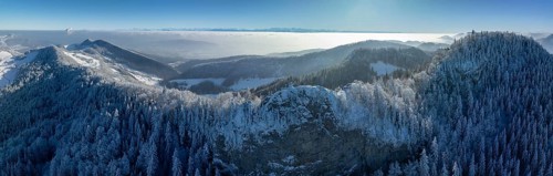 View over the first Jura chain with Belchenflueh in winter into the Central Plateau with high fog,