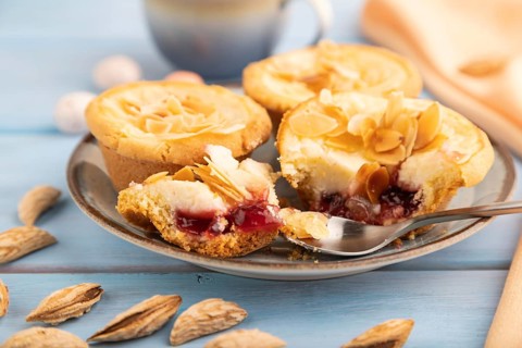 Traditional portuguese cakes pasteis de nata, custard small pies with almonds with cup of coffee on