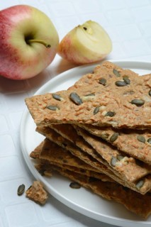 Crispbread with seeds on a plate and apple