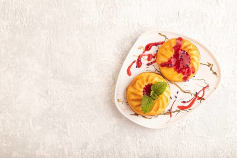 Semolina cheesecake with strawberry jam, lavender on gray concrete background. top view, flat lay,