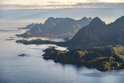 View of the coast in Ulvagsundet fjord and mountains in the evening light, Hurtigruten cruise ship