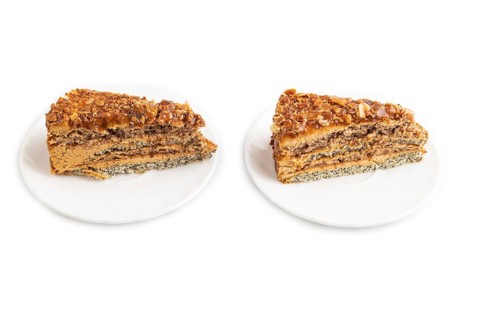 Walnut and hazelnut cake with caramel cream isolated on white background. side view