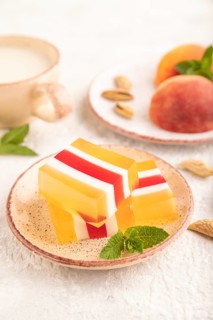 Almond milk and peach jelly on gray concrete background. side view, close up, selective focus