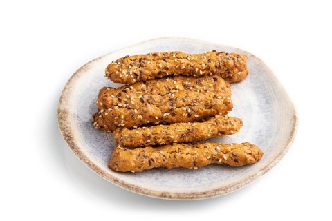Crumble cookies with seasme and almonds on ceramic plate isolated on white background. side view,