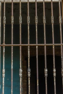 Bars over outside of glassless window in abandoned house in Istanbul, Tuerkiye