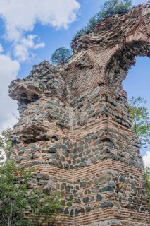 Ancient stone and brick archway into ruins of castle in Istanbul, Tuerkiye