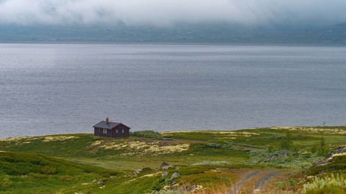 Shot of a hut on Lake Soenstevatn in the rain, landscape format, inland waters, log cabin, holiday