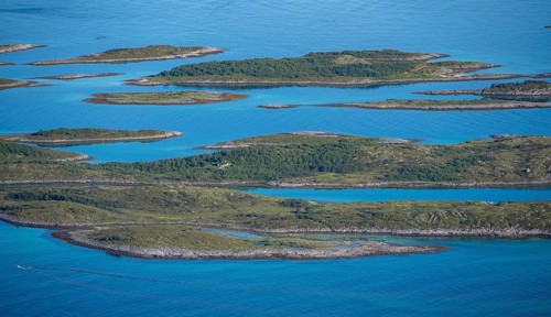 Rocky islands in the blue sea, sea with archipelago islands, Ulvagsundet, Vesteralen, Norway,