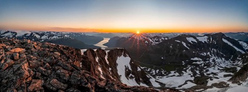 Panorama, view of mountains and fjord Faleidfjorden, sun star at sunset, summit of Skala, Loen,