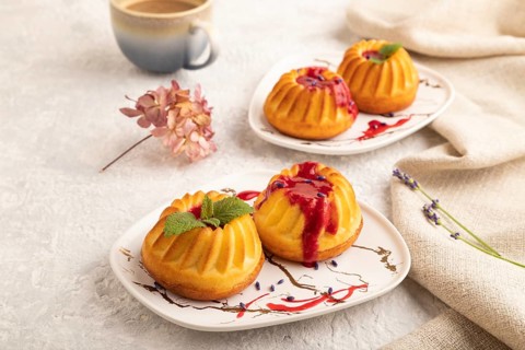 Semolina cheesecake with strawberry jam, lavender, cup of coffee on gray concrete background and