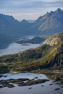 Fjord Raftsund and mountains in atmospheric evening light, view from the summit of Dronningsvarden