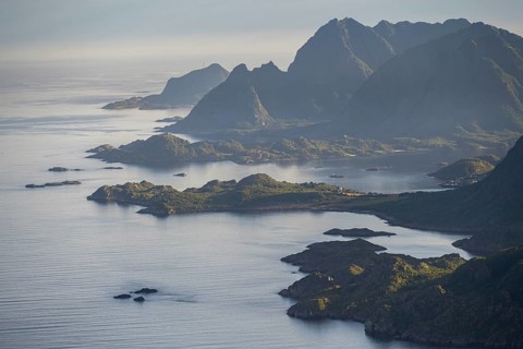 View of the coast in Ulvagsundet fjord and mountains in the evening light, Hurtigruten cruise ship