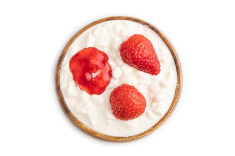 Grained cottage cheese with strawberry jam isolated on white background. top view, flat lay