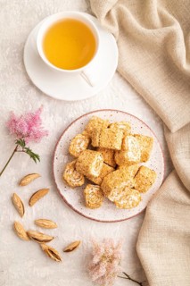 Traditional turkish delight (rahat lokum) with cup of green tea on a gray concrete background and