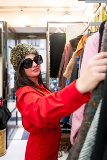 Vertical portrait of a beauty woman shopping in a second hand vintage store