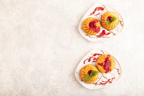 Semolina cheesecake with strawberry jam, lavender on gray concrete background. top view, flat lay,