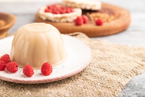 Buckwheat milk jelly on gray wooden background and linen textile. side view, close up, selective