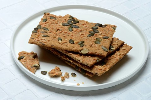 Crispbread with seeds on a plate, pumpkin seeds