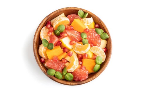 Vegetarian fruit salad of pumpkin, tangerine, pomegranate, grapefruit, sunflower microgreen sprouts