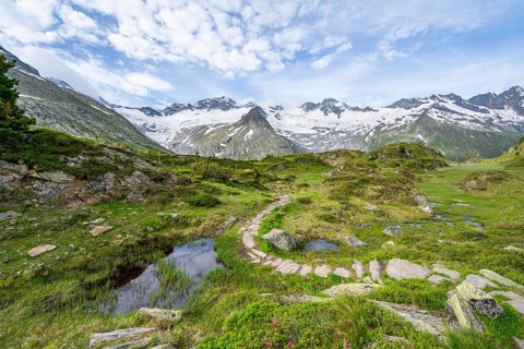 Hiking trail in picturesque mountain landscape, mountain peaks with snow and glacier Hornkees and