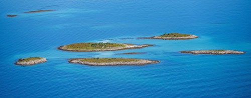 Rocky islands in the evening light, sea with archipelago islands, Ulvagsundet, Vesteralen, Norway,