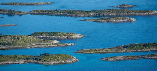 Rocky islands in the blue sea, sea with archipelago islands, Ulvagsundet, Vesteralen, Norway,