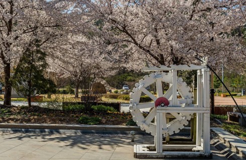 Hwanggan, South Korea, April 8, 2020: For editorial use only. Closeup of white wooden waterwheel