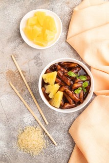 Tteokbokki or Topokki, fried rice cake stick, popular Korean street food with spicy jjajang sauce