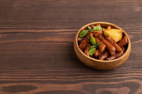 Tteokbokki or Topokki, fried rice cake stick, popular Korean street food with spicy jjajang sauce