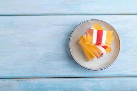 Almond milk and peach jelly on blue wooden background. top view, flat lay, copy space