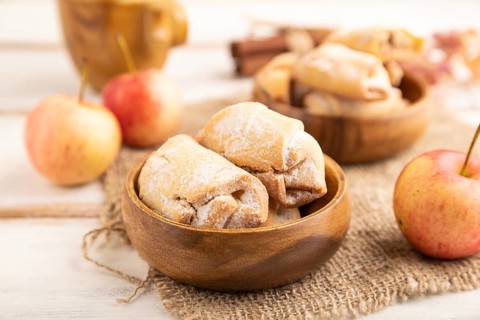 Homemade sweet cookie with apple jam and cup of coffee on white wooden background and linen textile