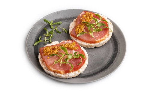Puffed rice cake sandwiches with jerky salted meat, microgreen and mustard isolated on white