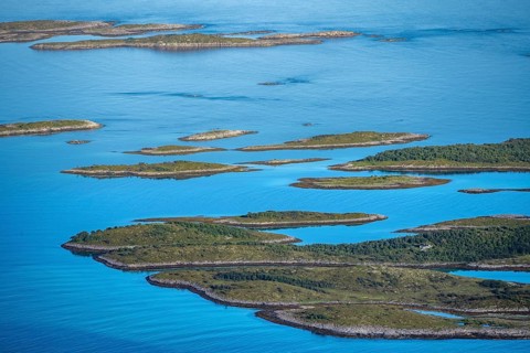 Rocky islands in the blue sea, sea with archipelago islands, Ulvagsundet, Vesteralen, Norway,